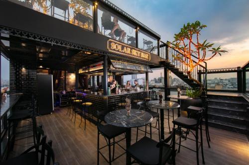 a restaurant with tables and chairs on top of a building at GM Premium Hotel in Hanoi