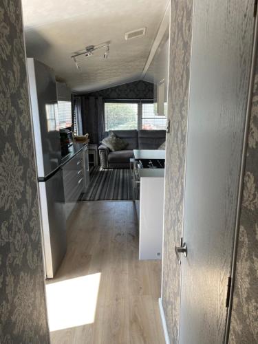 an open door to a kitchen and a living room at Tingdene caravan park north dene in Lowestoft