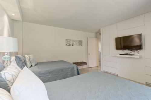 a bedroom with two beds and a flat screen tv at Sea Vista in South Padre Island