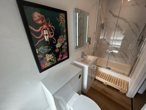 a bathroom with a white toilet and a sink at The Hideaway - 2-Bedroom Apartment with outdoor terrace & free parking in Lancaster