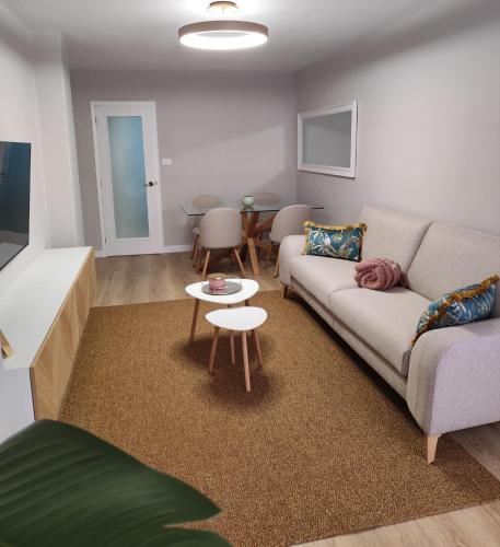 a living room with a couch and a table at Cangas con encanto in Cangas de Morrazo