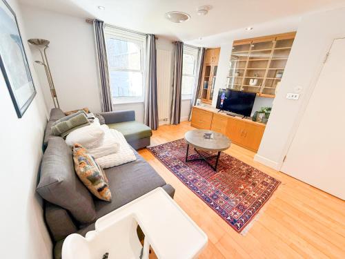 a living room with a couch and a table at Spacious Detached Houses with FREE PARKING near Little Venice, Paddington & Hyde Park by Staylio London in London