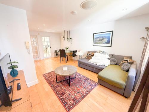 a living room with a couch and a table at Spacious Detached Houses with FREE PARKING near Little Venice, Paddington & Hyde Park by Staylio London in London