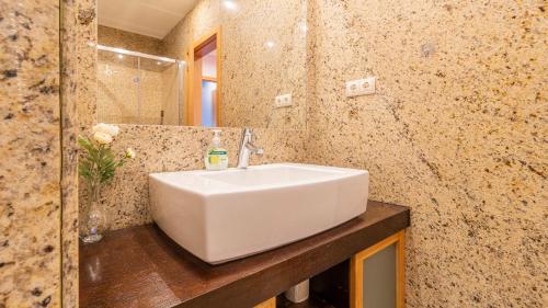 a bathroom with a white sink and a counter at Com o Douro à vista in Jovim