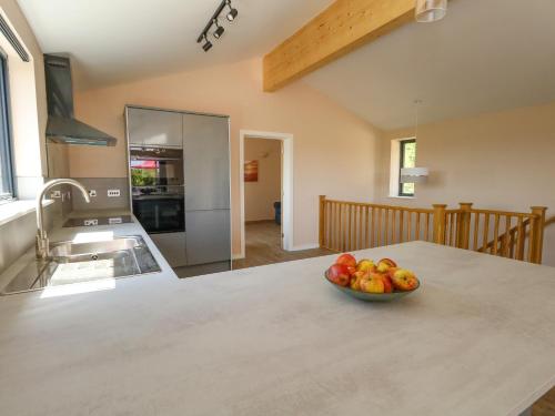 a bowl of fruit on a counter in a kitchen at Frogwell in Sherborne