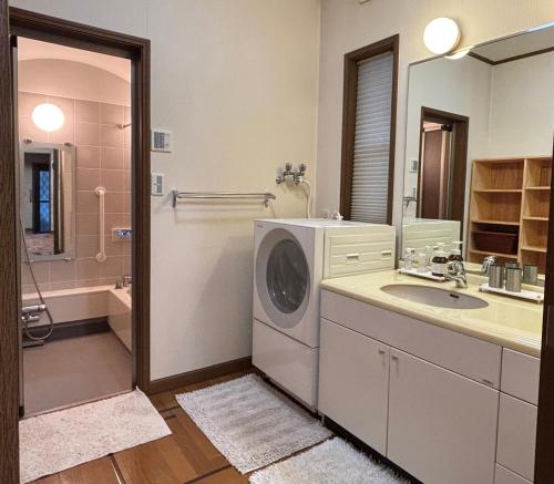 a bathroom with a washing machine and a sink at S & K Garden House in Tokyo