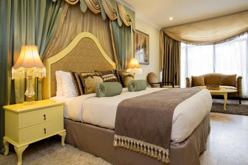 a bedroom with a large bed with a canopy at Villa Monticello Boutique Hotel in Accra