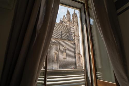 a view of a church from a window at La Dimora alle Scalette in Orvieto