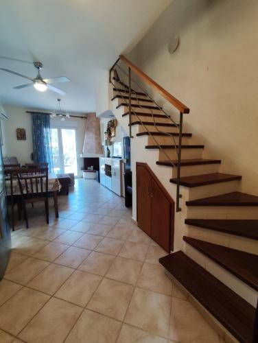 a staircase in a room with a kitchen and a living room at Nikiti Blue Horizon in Nikiti