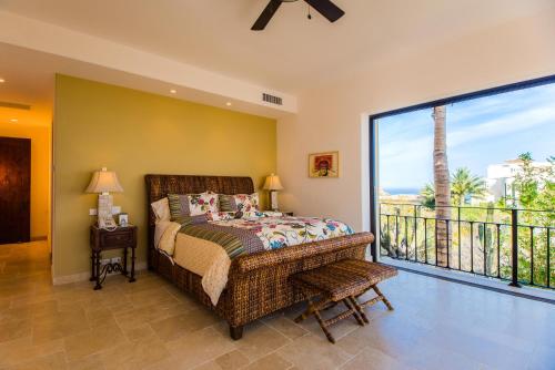 a bedroom with a bed and a balcony at Villa de Suenos by Cabo Villas in San José del Cabo