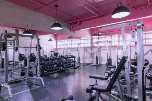 a gym with a lot of equipment in a room at Lux at 15, Pool, Gym and Stylish City Stay in Hatillo