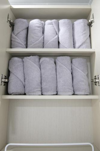 a bunch of towels are stacked in a bathroom at ANNA Stay in Seoul