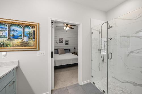 a bathroom with a shower and a bedroom at Hill Country Hideout in FBGTX in Fredericksburg
