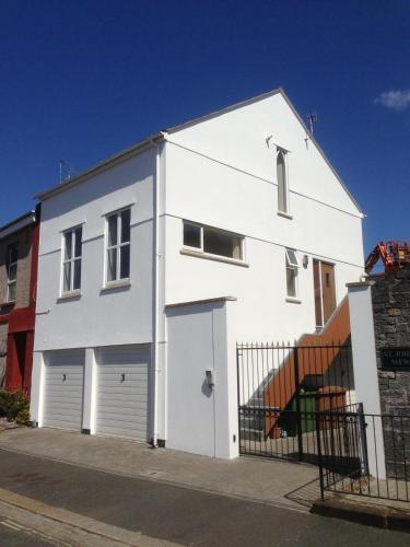 a white house with two garage at 'Hidden Jewel' city centre + FREE PARKING in Plymouth
