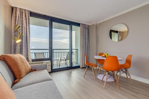 a living room with a couch and a table with chairs at Stunning Oceanfront Studio Suite, Dogs OK! 1228 in Myrtle Beach