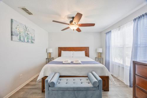 a bedroom with a bed and a ceiling fan at Cozy Stylish Townhome in Davenport