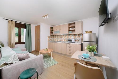 a living room with a couch and a kitchen at Emmas House in Panayia