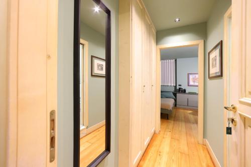 a mirror in a hallway with a room at La Pigna Suites in Verona