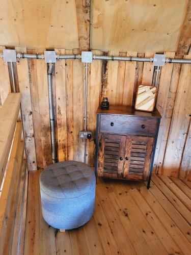 a corner of a room with a stool and a table at The Stables & Silos in Braintree