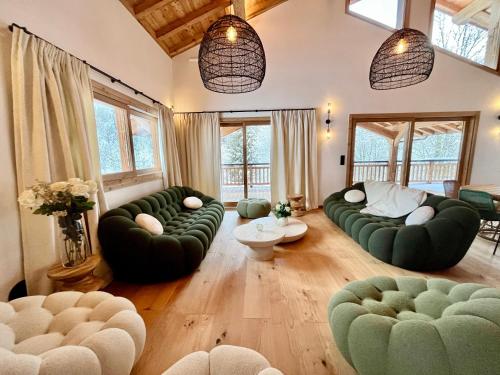 a large living room with green couches and chairs at Chalet Asgard in Morzine