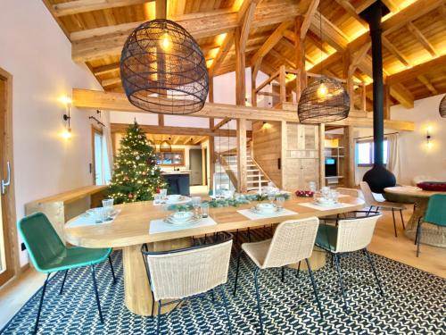 a dining room with a large wooden table and chairs at Chalet Asgard in Morzine