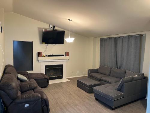 a living room with two couches and a fireplace at Emiliana in Palmdale