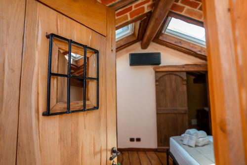 a wooden door with a window in a room at Agriturismo San Sebastiano in Finale Ligure