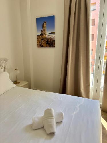 a bedroom with a bed with two towels on it at Maison Bonaparte in Bastia