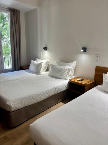 a bedroom with two beds and a window at Maison Bonaparte in Bastia