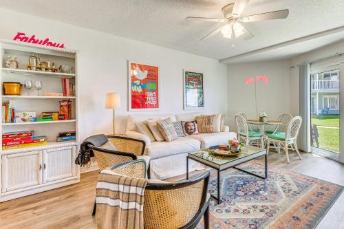 a living room with a couch and a table at Sea La Vie Condo Pensacola Beach Access! in Pensacola Beach