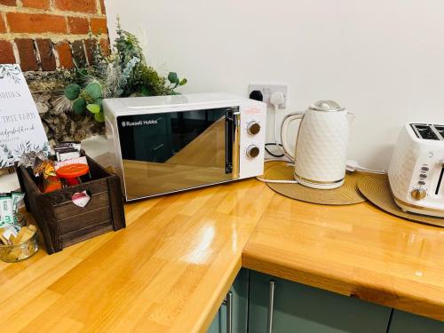 a microwave oven sitting on top of a counter at The Stables & Silos in Braintree