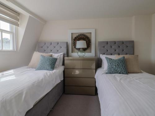 two beds sitting next to each other in a bedroom at Sea Holly in Lyme Regis