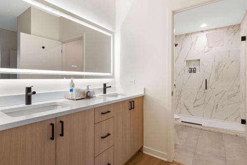 a bathroom with a sink and a shower at K2 Sky High Apartments with Stunning Chicago Views in West Loop in Chicago