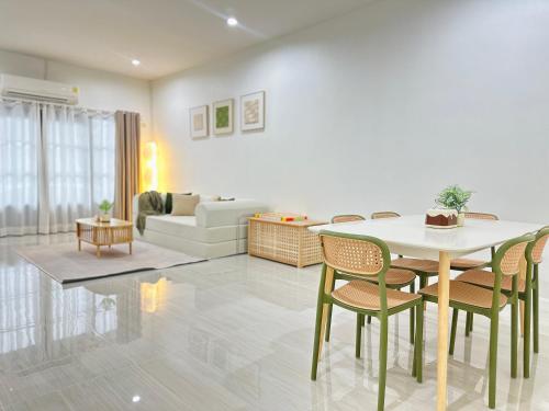 a living room with a table and chairs at Midori Haus-7mins to LeeGarden in Hat Yai
