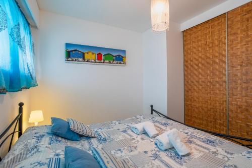 une chambre avec un lit avec des oreillers bleus dessus dans l'établissement LE CHANTILLY AP4464 by RIVIERA HOLIDAY HOMES, à Cagnes-sur-Mer