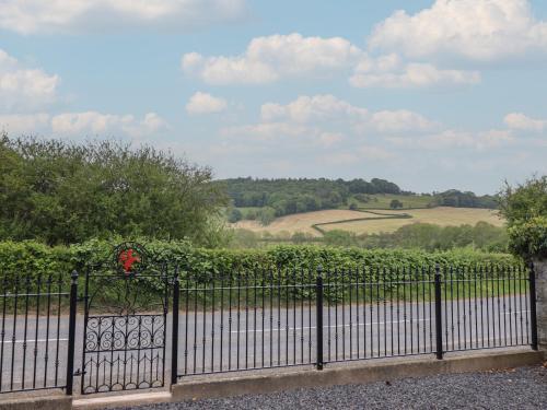 a black fence with a view of a field at Upper Dolarddyn in Welshpool