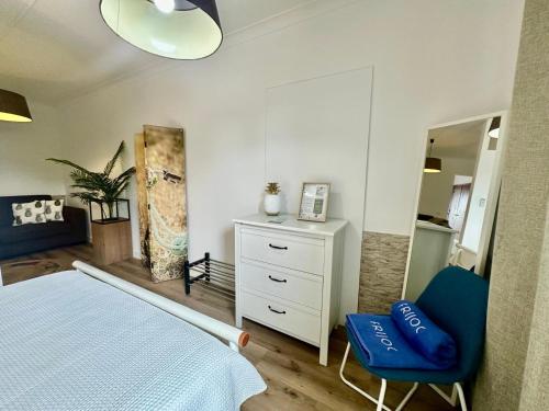 a bedroom with a bed and a dresser and a mirror at AZORES PEDRA APARTMENTS - T0 e T1 in Ponta Delgada