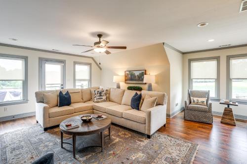 a living room with a couch and a table at Farm and Lake Views Rural Mississippi Loft Apt in Hernando