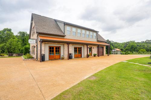 a large house with a large driveway at Farm and Lake Views Rural Mississippi Loft Apt in Hernando