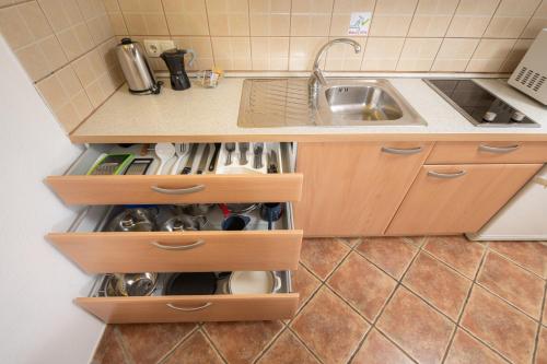 a kitchen with a sink and a counter with wooden drawers at Rooms & Apartments Pr Matjon in Bled