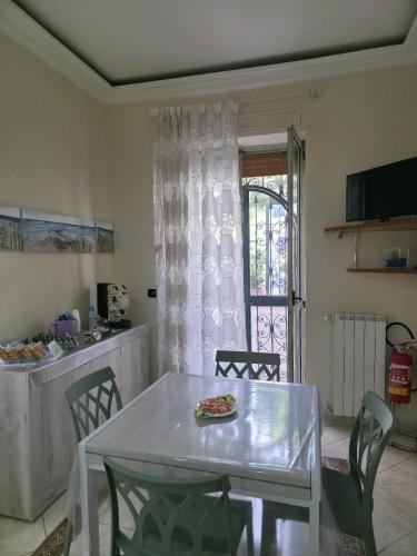 a dining room with a table and a pizza on it at Domus Mirabilis in Torre del Greco