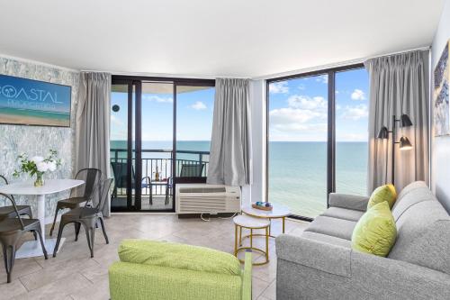 a living room with a view of the ocean at Remodeled Dec23, Best Floorpan! DogsOK 1206 in Myrtle Beach