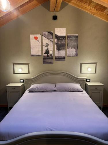 a bedroom with a large bed with two night stands at Riverside room Pierre in Pontboset