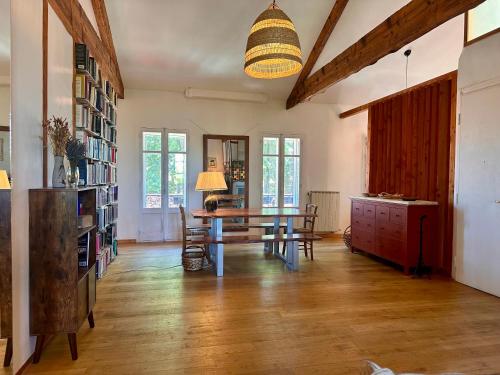 une salle à manger avec une table et des chaises dans une pièce dans l'établissement Loft transversant avec balcon, à Avignon