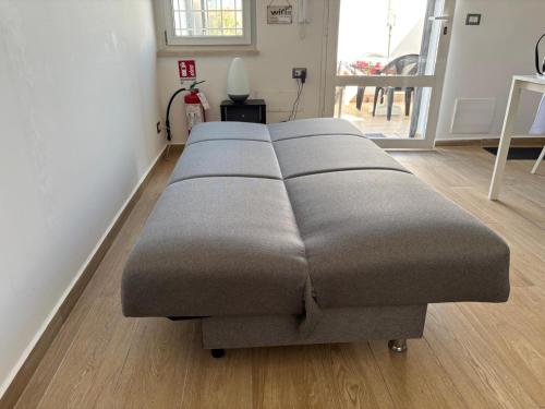 a row of four beds in a room at Casa Amare Aeroporto Fiumicino in Focene