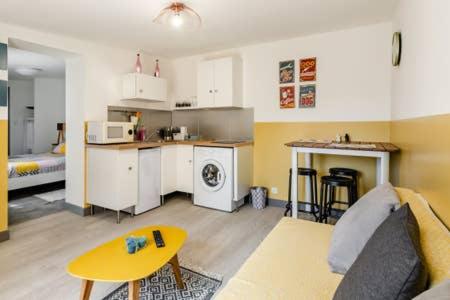 un salon avec un canapé et une cuisine dans l'établissement Propriété vue mer avec jardin et terrasse proche port et calanques, à La Ciotat