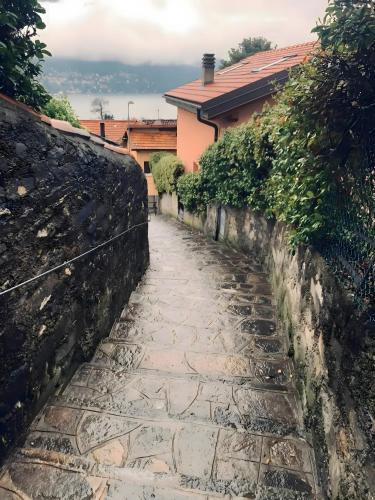 a stone path in front of a house at Suite panoramica in Guest House in Moltrasio