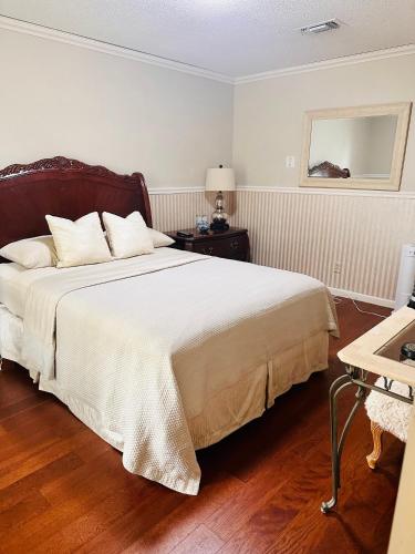 a bedroom with a large bed and a table at Nice and peaceful bedroom in Wake Village