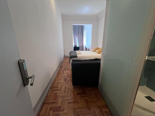 a small room with a bed and a small hallway at Castilho 63 Hostel & Suites in Lisbon