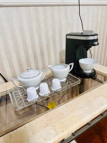 three bowls on a tray next to a coffee maker at Nice and peaceful bedroom in Wake Village